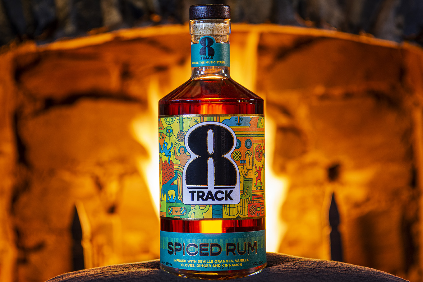 A bottle of 8Track Rum in front of a roaring open fire at the Polgooth Inn in Cornwall