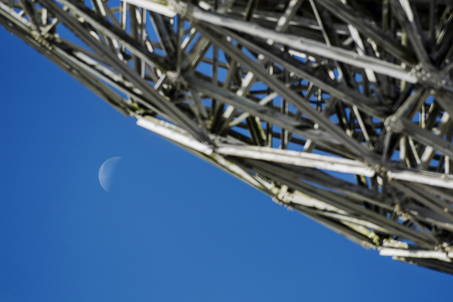 A view of the new moon with satellite dish in the foreground at Goonhilly Earth Station