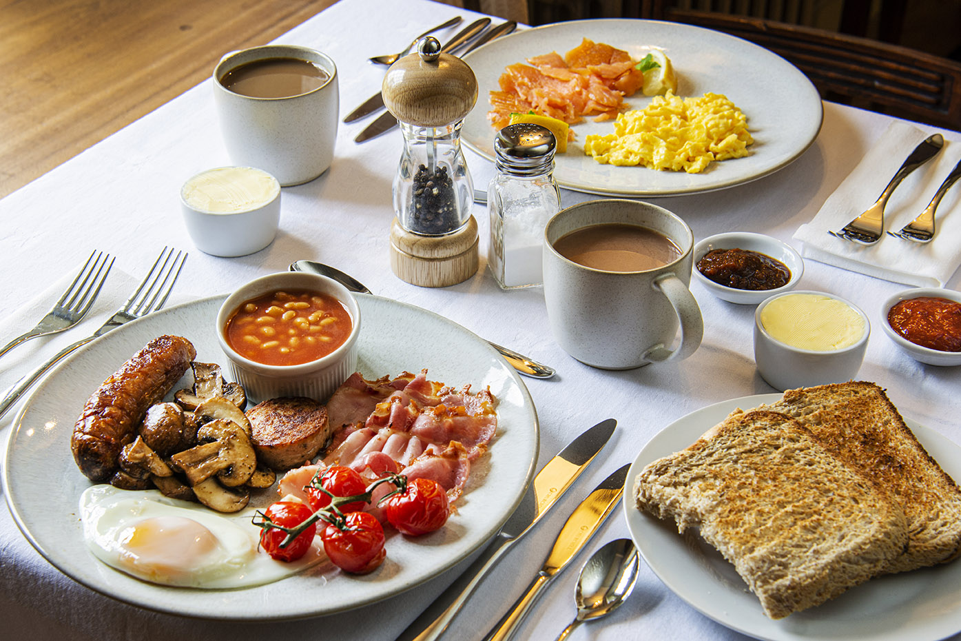 view of the breakfast table with tea, coffee, a full Cornish cooked breakfast and smoked salmon and scrambled eggs