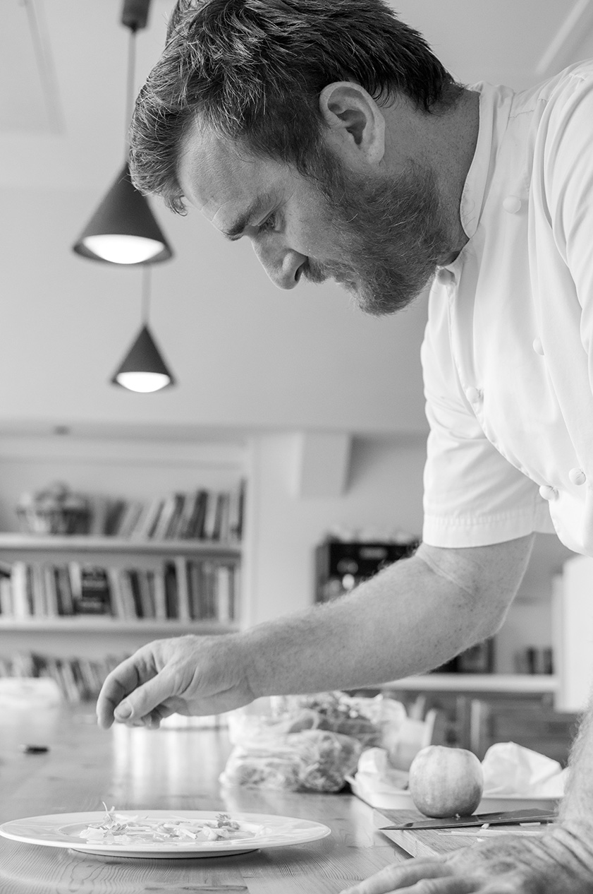 black and white photo of Jack Stein at work preparing ceviche of sea bass 