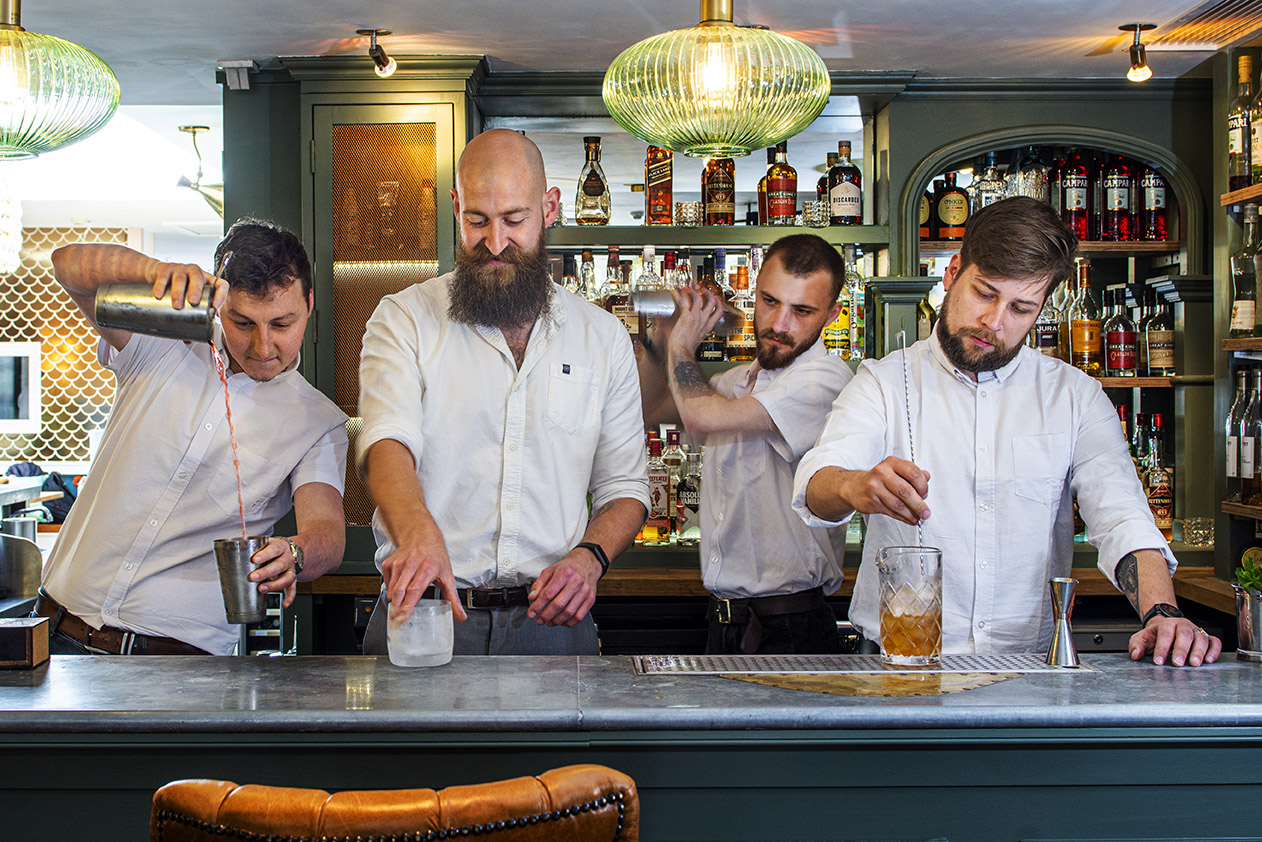 Four barman making cocktails in the bar of the Lemon Street Longstore